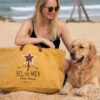 sac plage xl jaune Grand sac de plage XXL "Sel de Mer" coloris jaune safran posé sur le sable à côté d'un chien Golden Retriever. Cabas éco-responsable en toile recyclée et anses en cuir, idéal pour les vacances et les sorties estivales